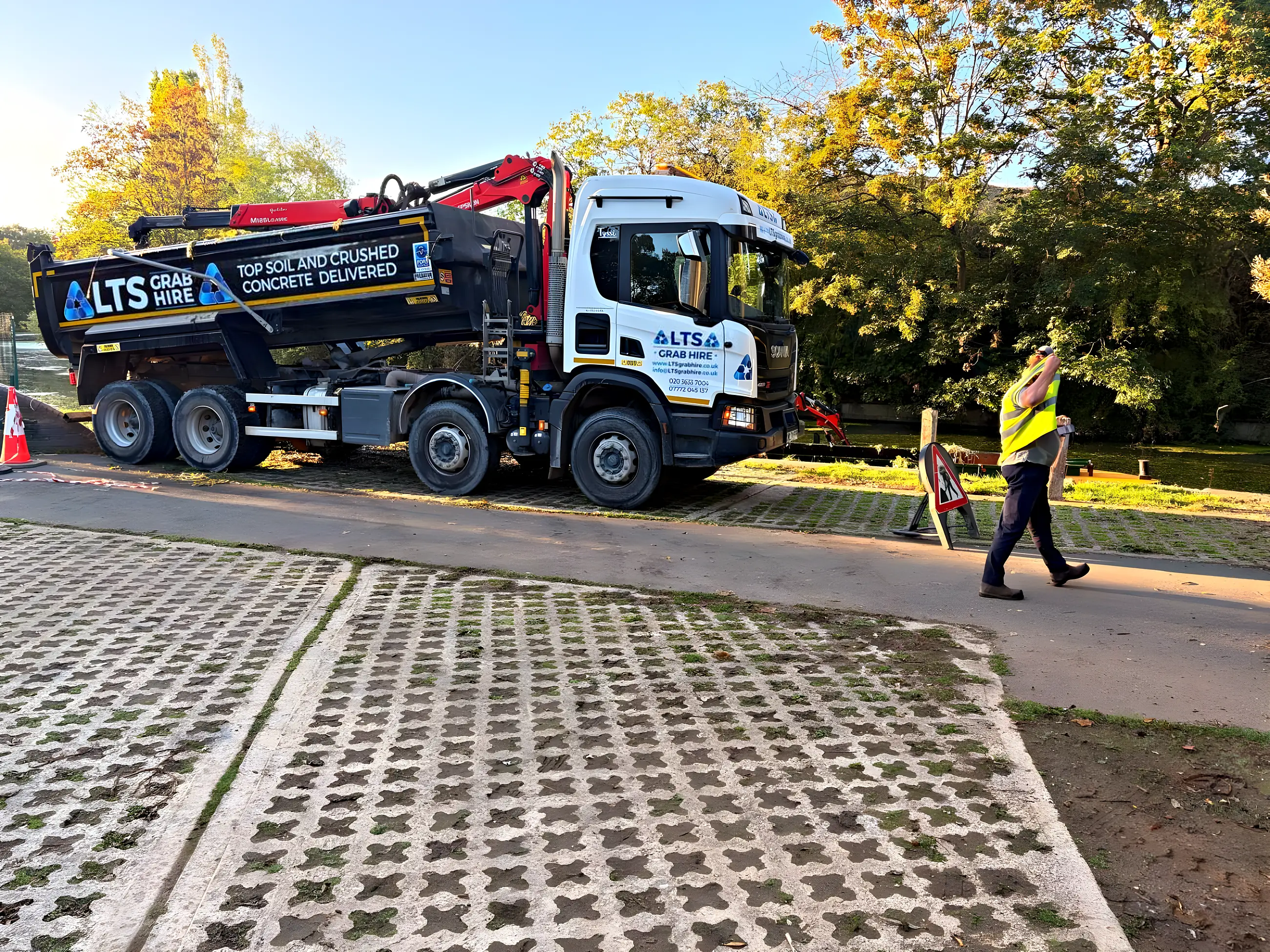 The eight-wheel grab lorry with its body raised on a towpath job