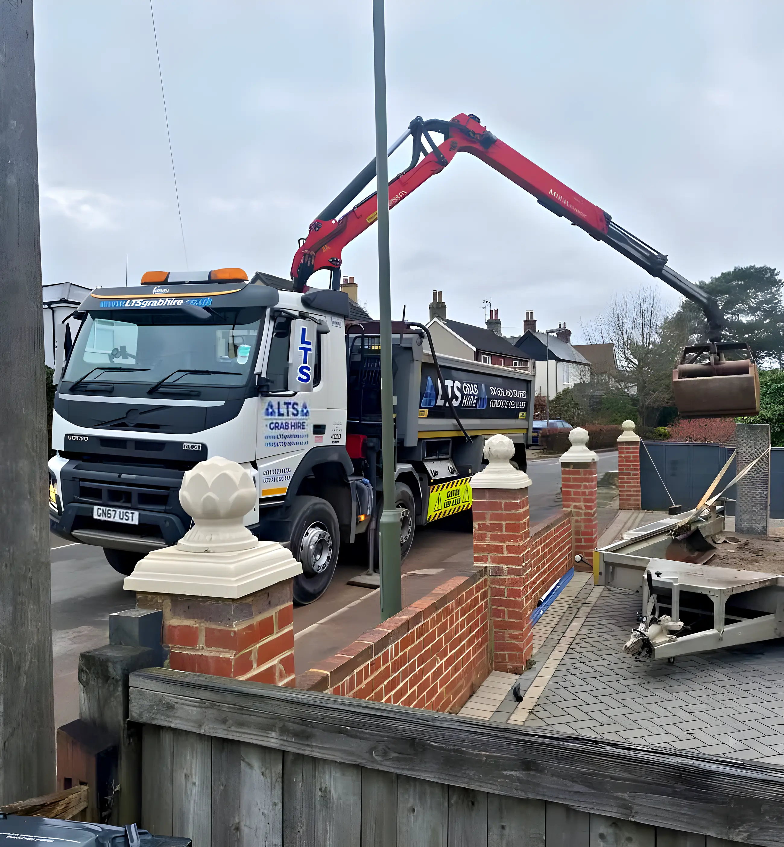 The arm lifting over a garden wall