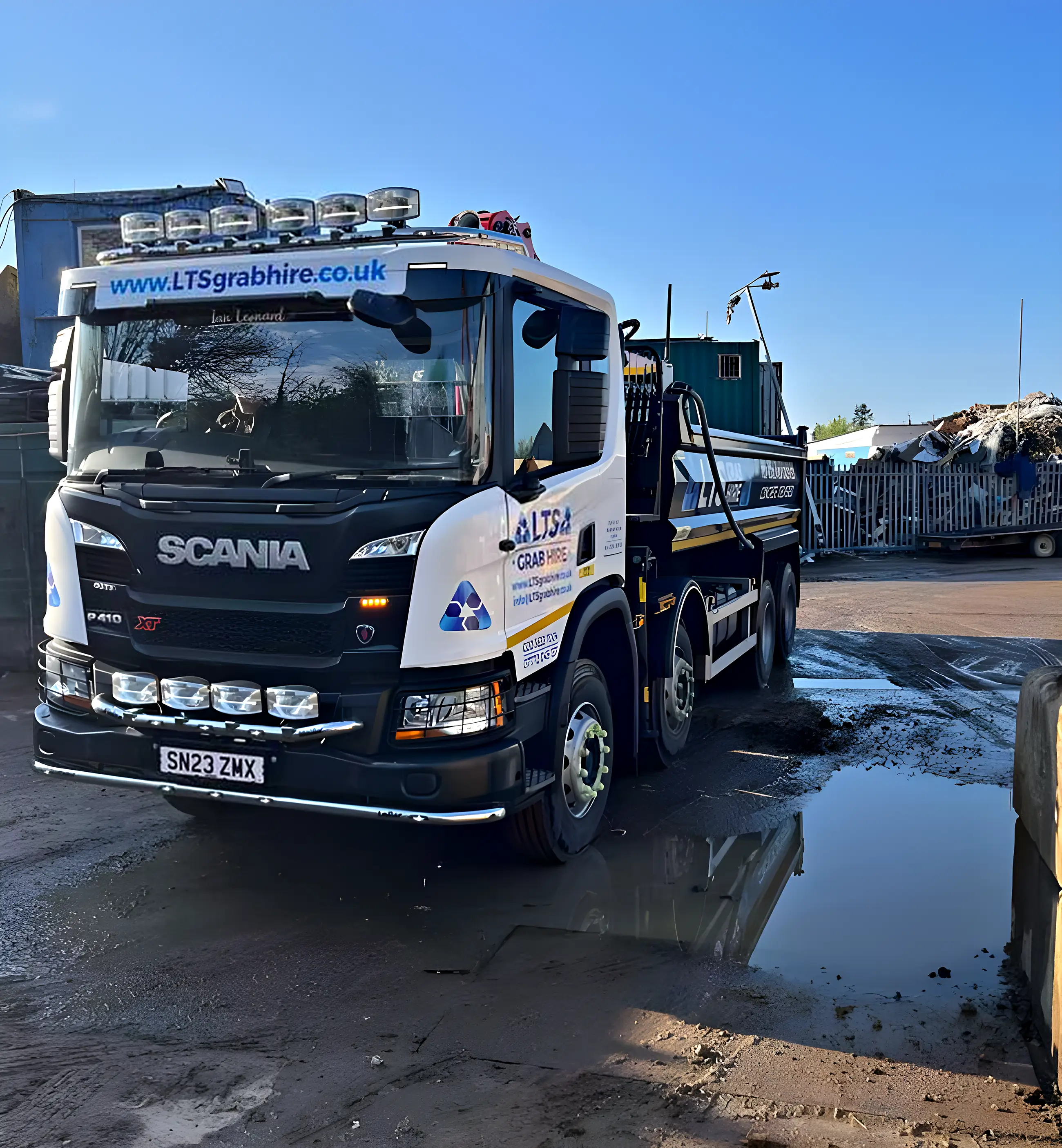 The eight-wheel Scania grab lorry on a towpath job, cones out